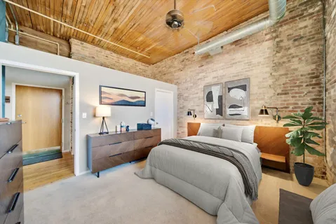 a bedroom with furniture and a large mirror