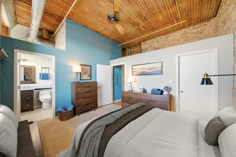 a bedroom with a bed dresser and a window