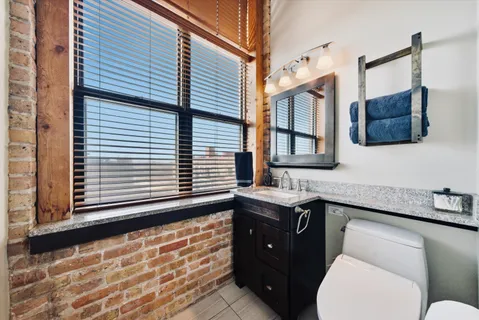 a bathroom with a toilet sink and mirror