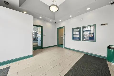 an empty room with windows and ceiling fan