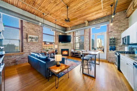 a living room with fireplace furniture and a wooden floor