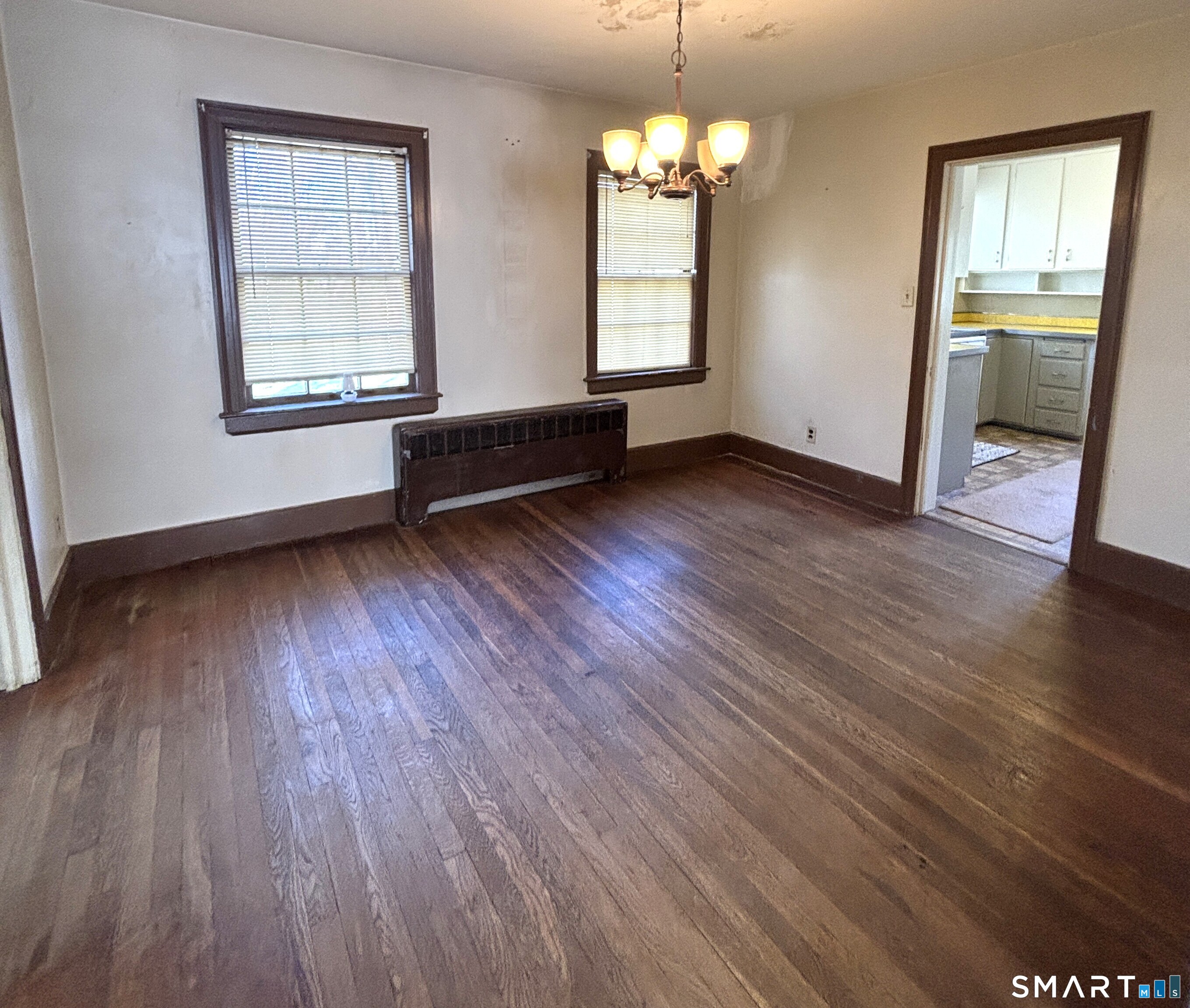 136 Broadway Street Colchester, CT 06415 - Photo 11 of 35 an empty room with wooden floor and windows
