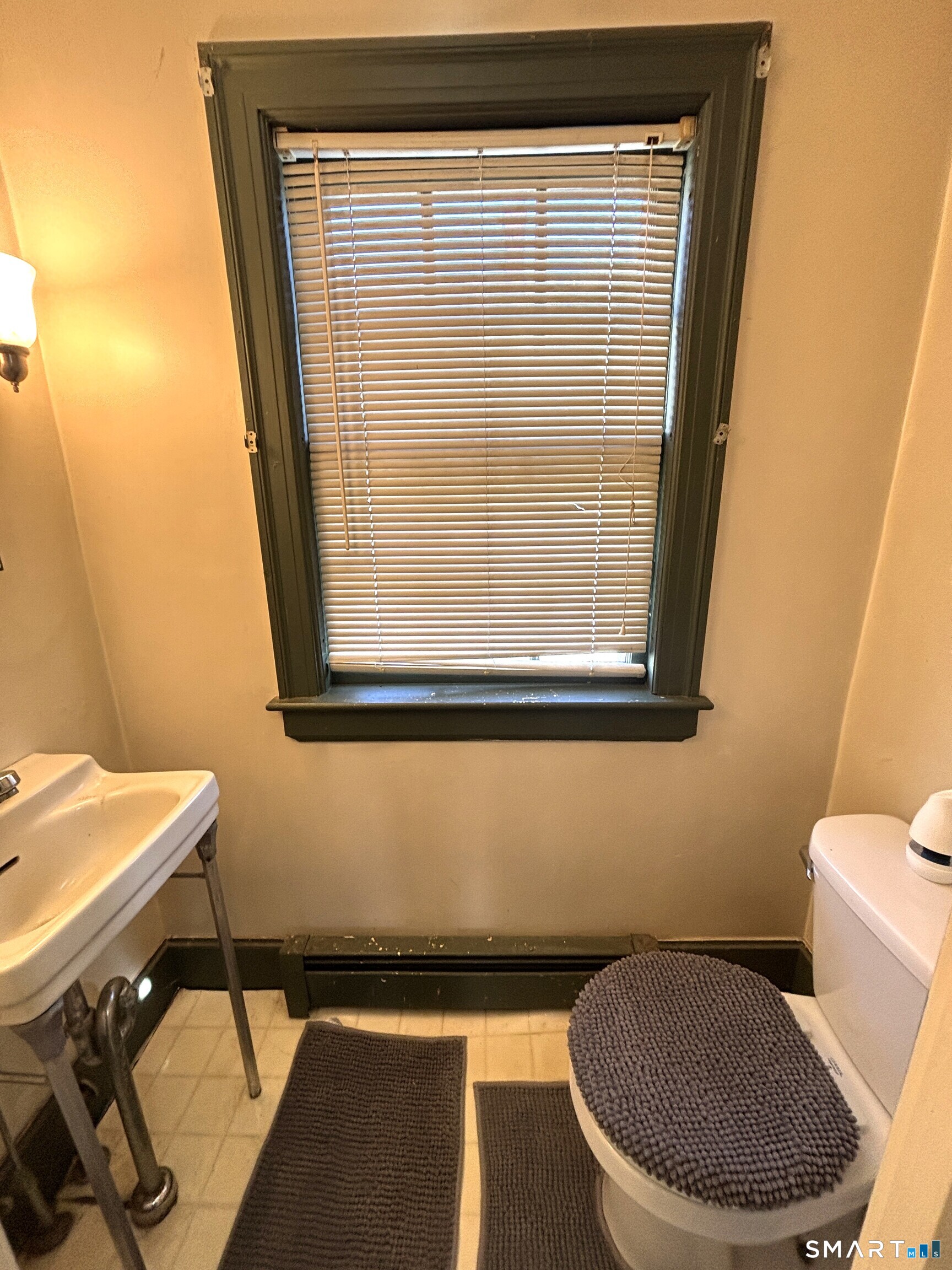 136 Broadway Street Colchester, CT 06415 - Photo 12 of 35 a bathroom with a toilet and a sink