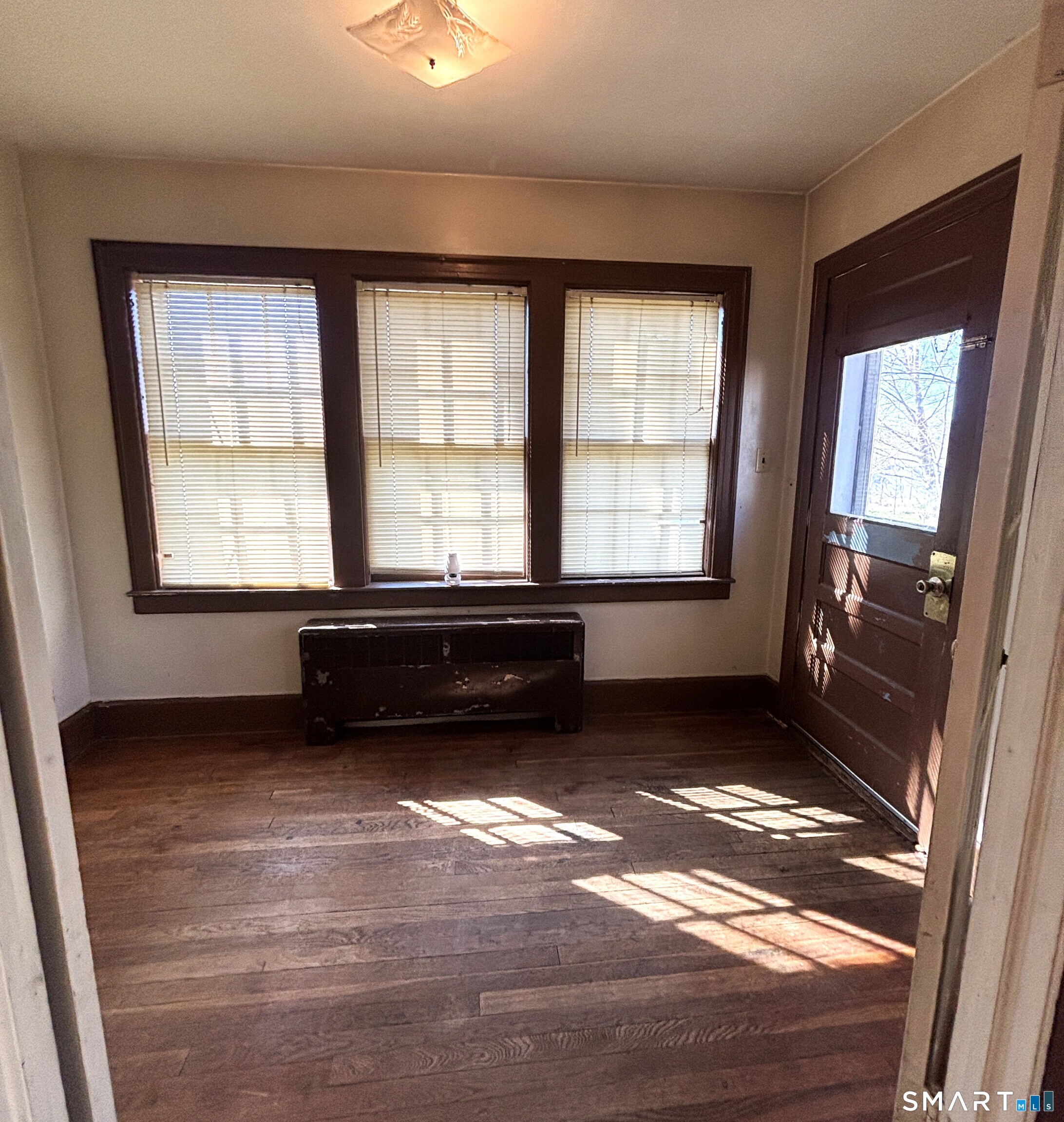 136 Broadway Street Colchester, CT 06415 - Photo 16 of 35 a view of a room with wooden floor and a window
