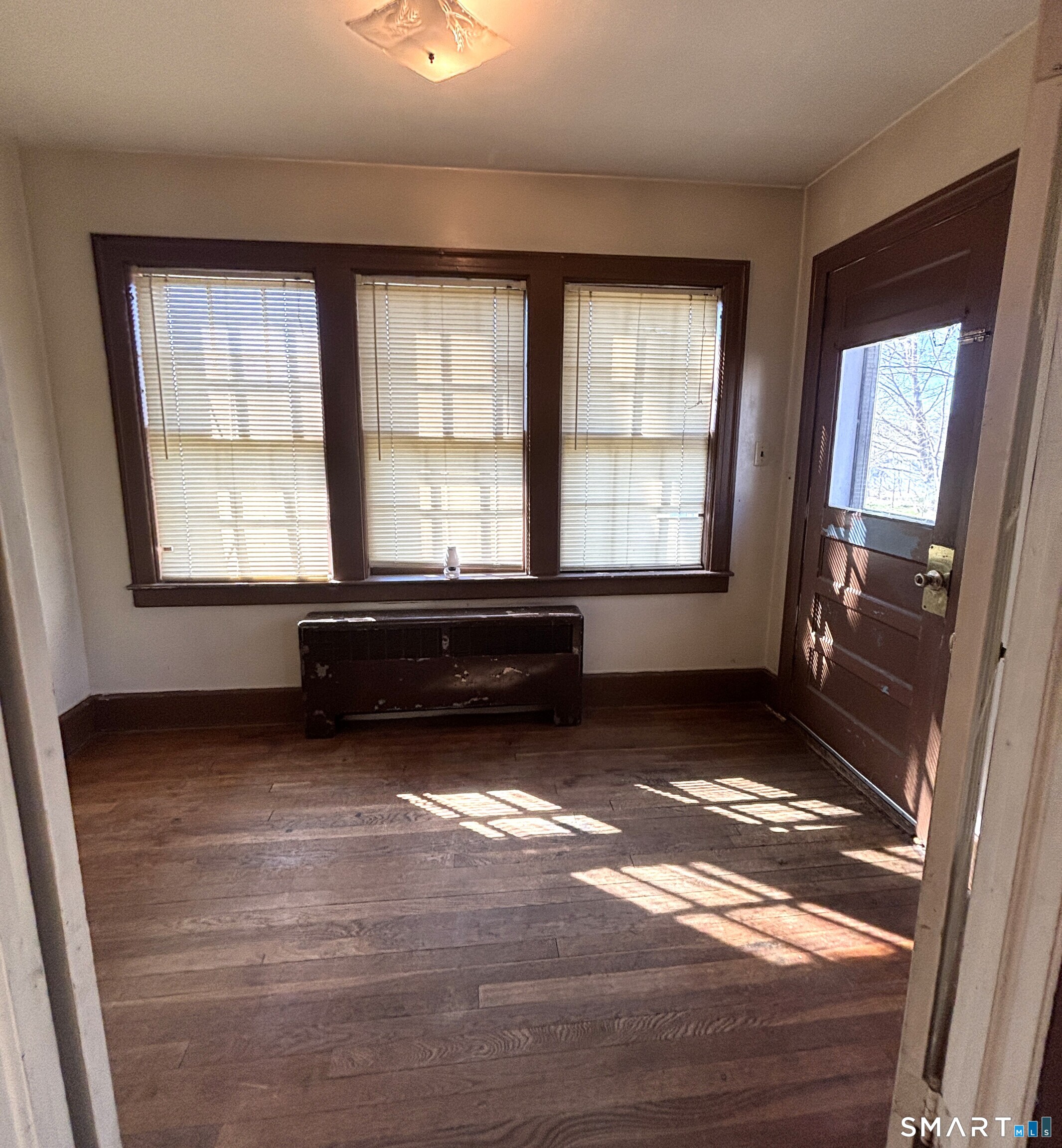 136 Broadway Street Colchester, CT 06415 - Photo 18 of 35 a view of an empty room with a fireplace and a window