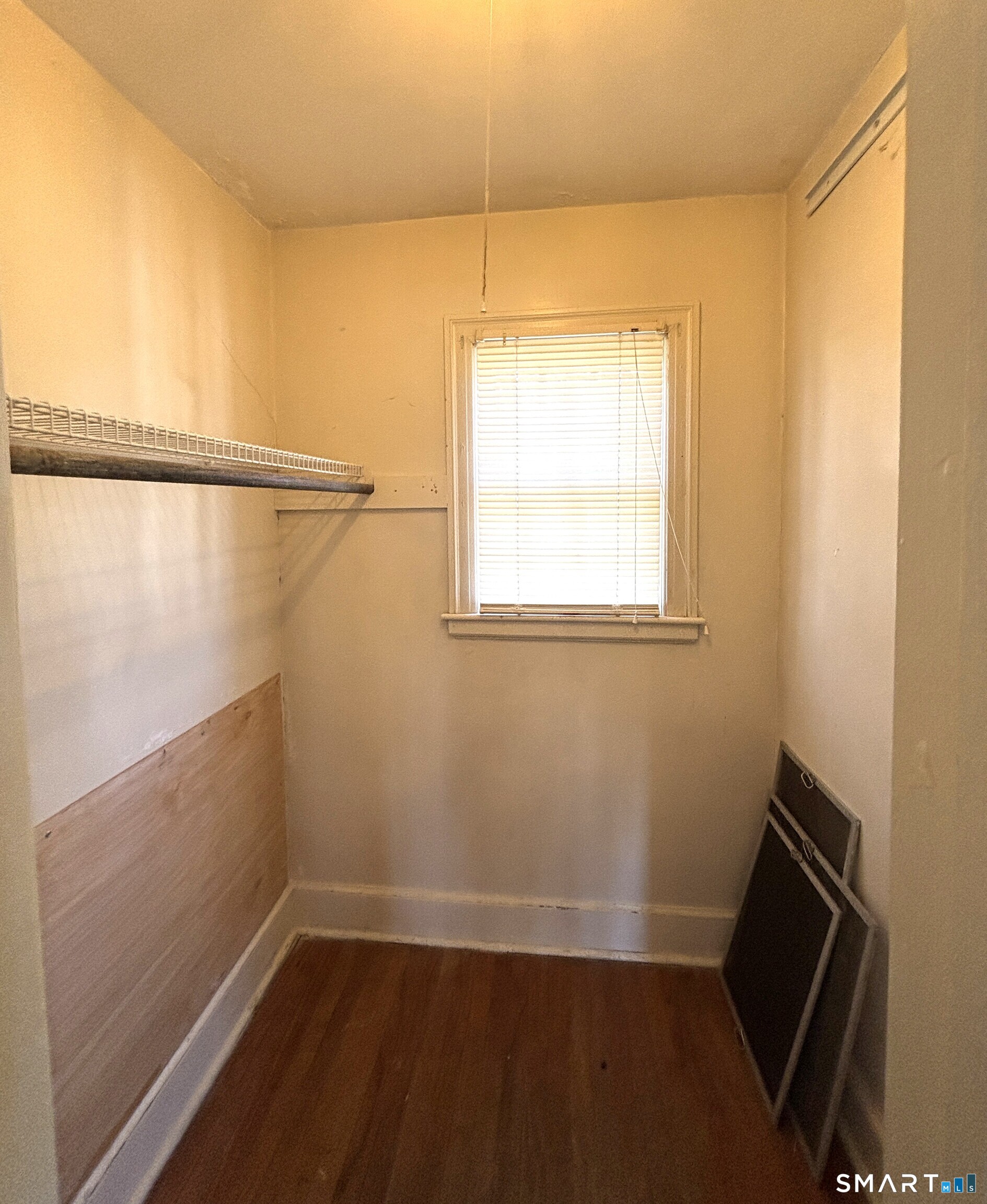 136 Broadway Street Colchester, CT 06415 - Photo 21 of 35 a view of a room with wooden floor and small window