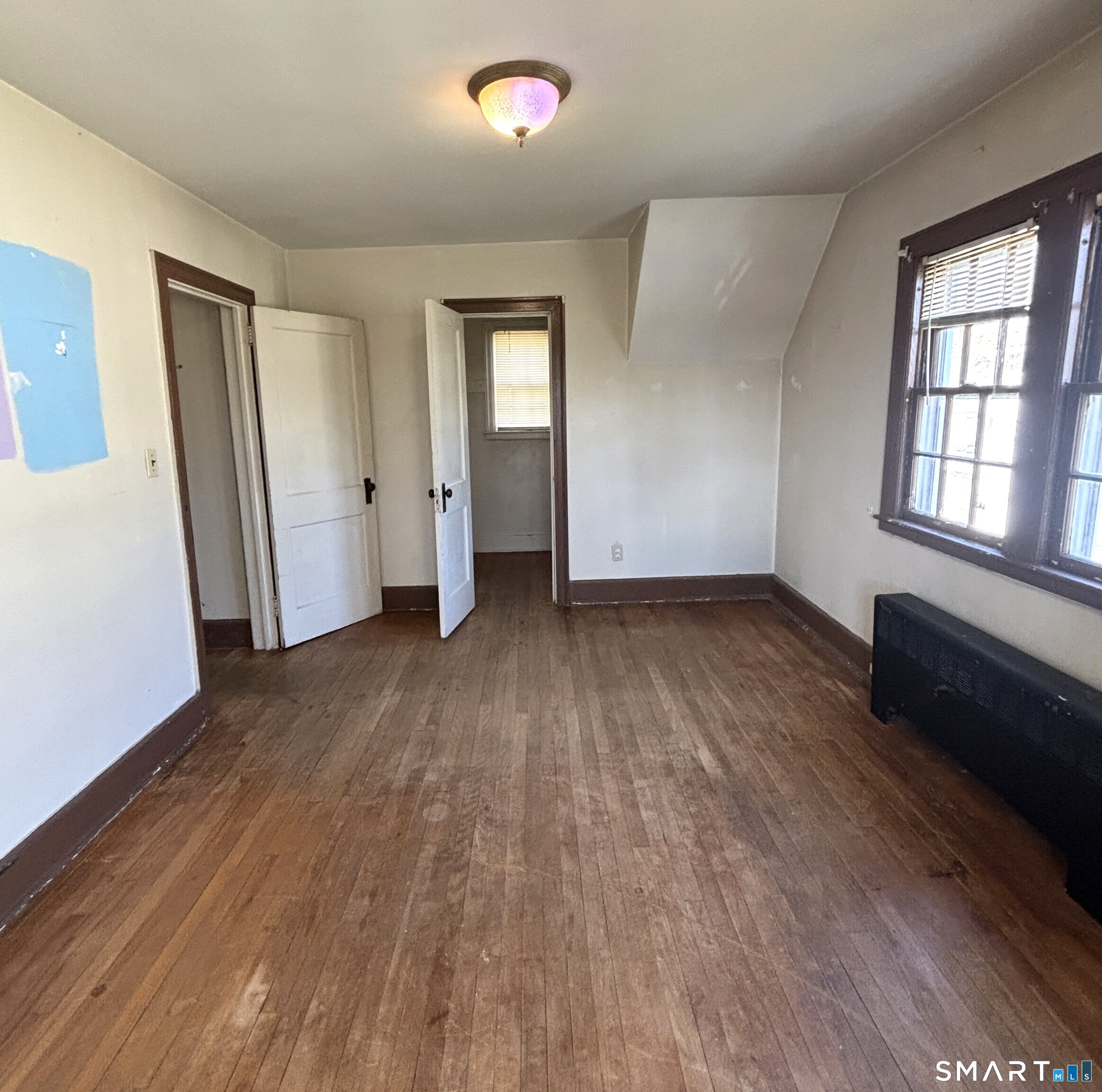 136 Broadway Street Colchester, CT 06415 - Photo 22 of 35 an empty room with wooden floor and windows