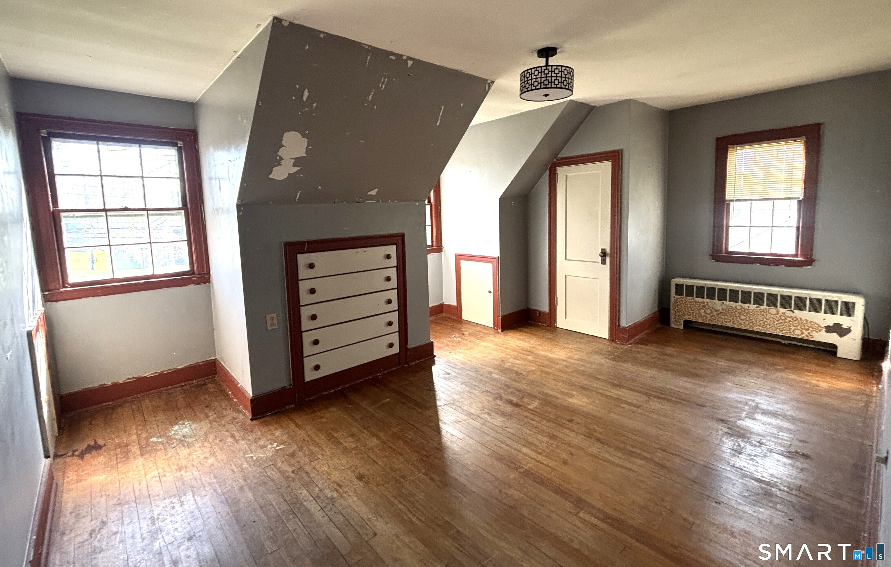 136 Broadway Street Colchester, CT 06415 - Photo 23 of 35 an empty room with wooden floor closet and windows