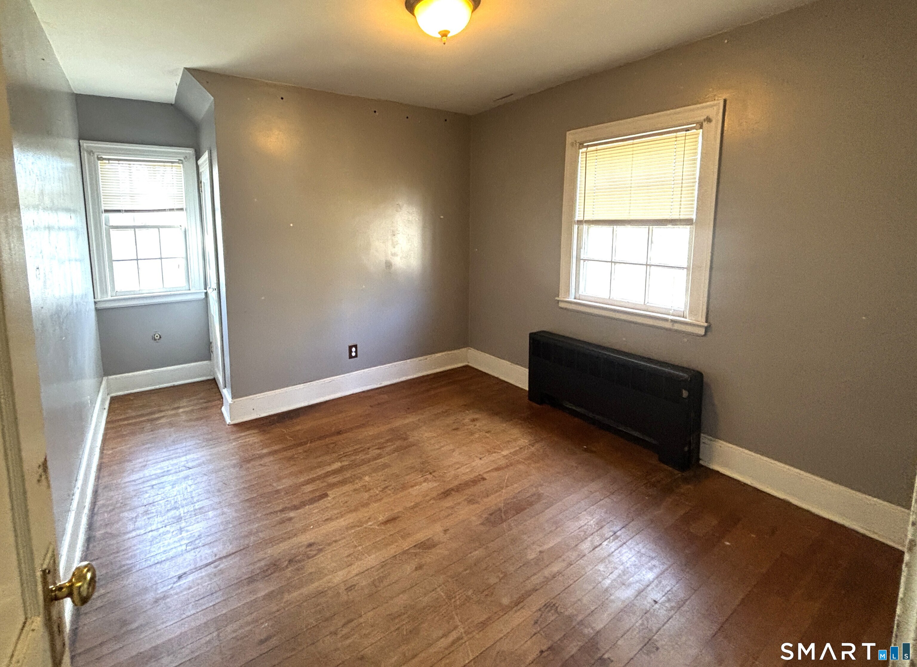136 Broadway Street Colchester, CT 06415 - Photo 26 of 35 an empty room with wooden floor and windows