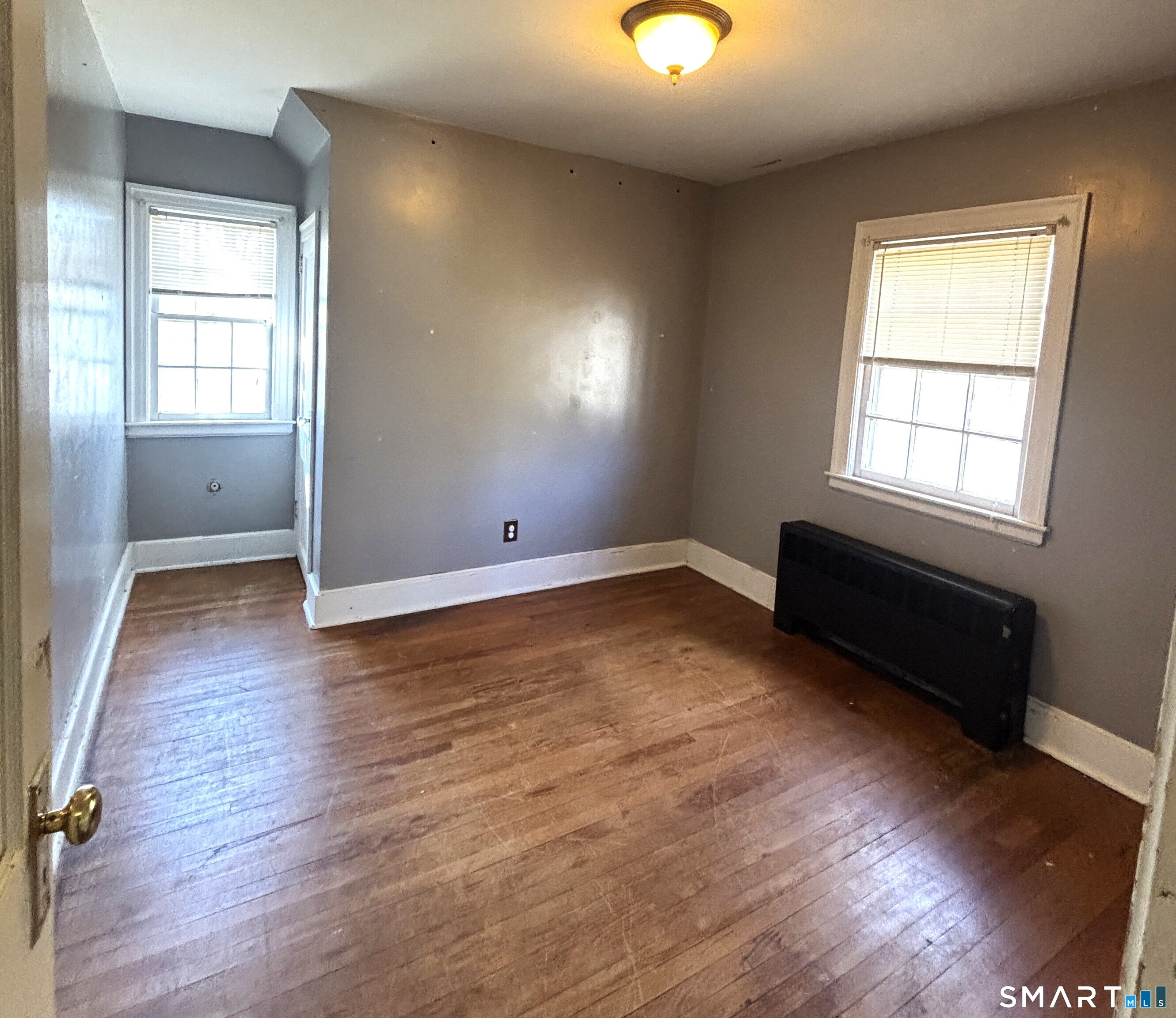 136 Broadway Street Colchester, CT 06415 - Photo 27 of 35 an empty room with wooden floor and windows