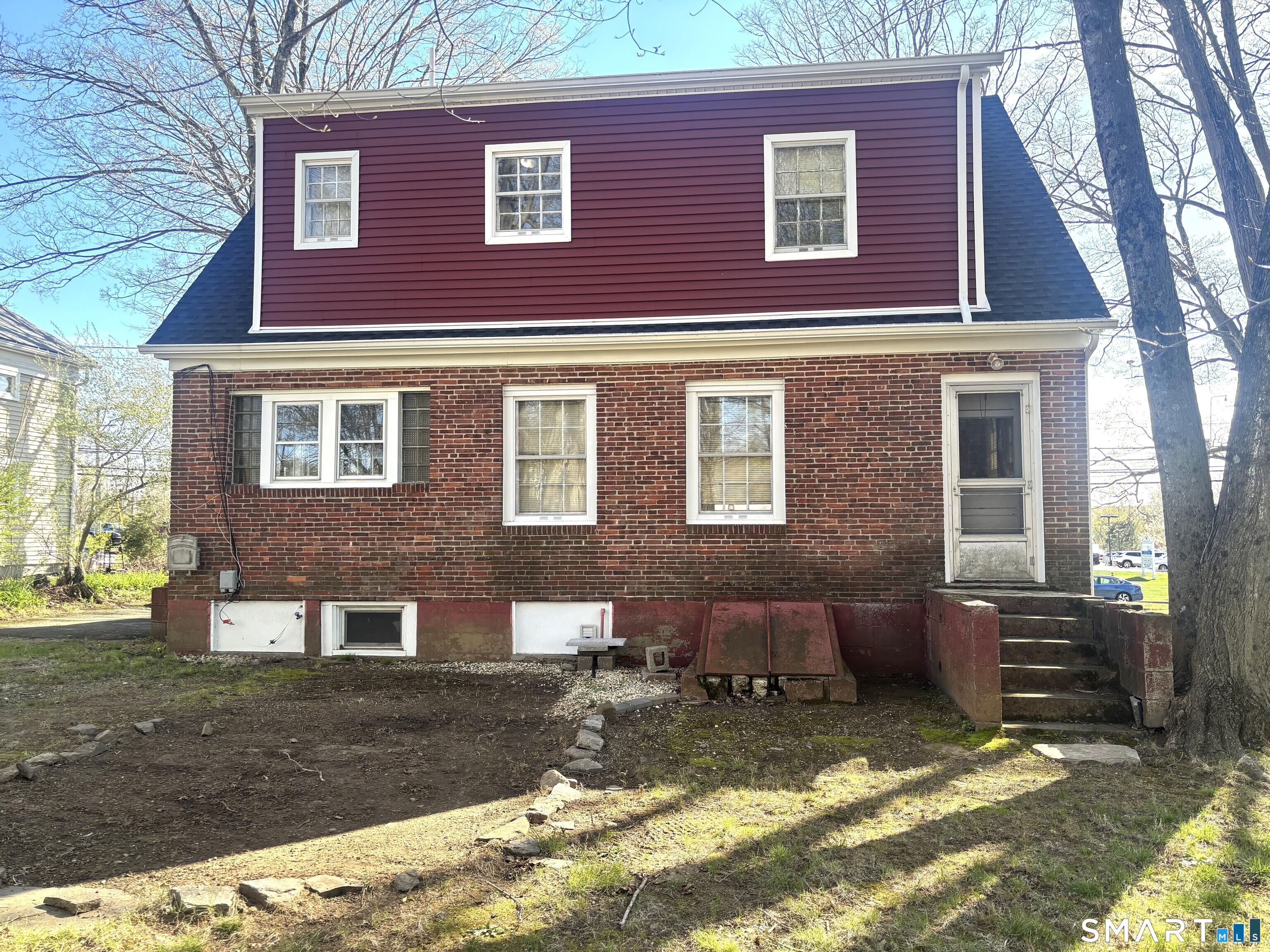 136 Broadway Street Colchester, CT 06415 - Photo 32 of 35 a view of a brick house with a yard