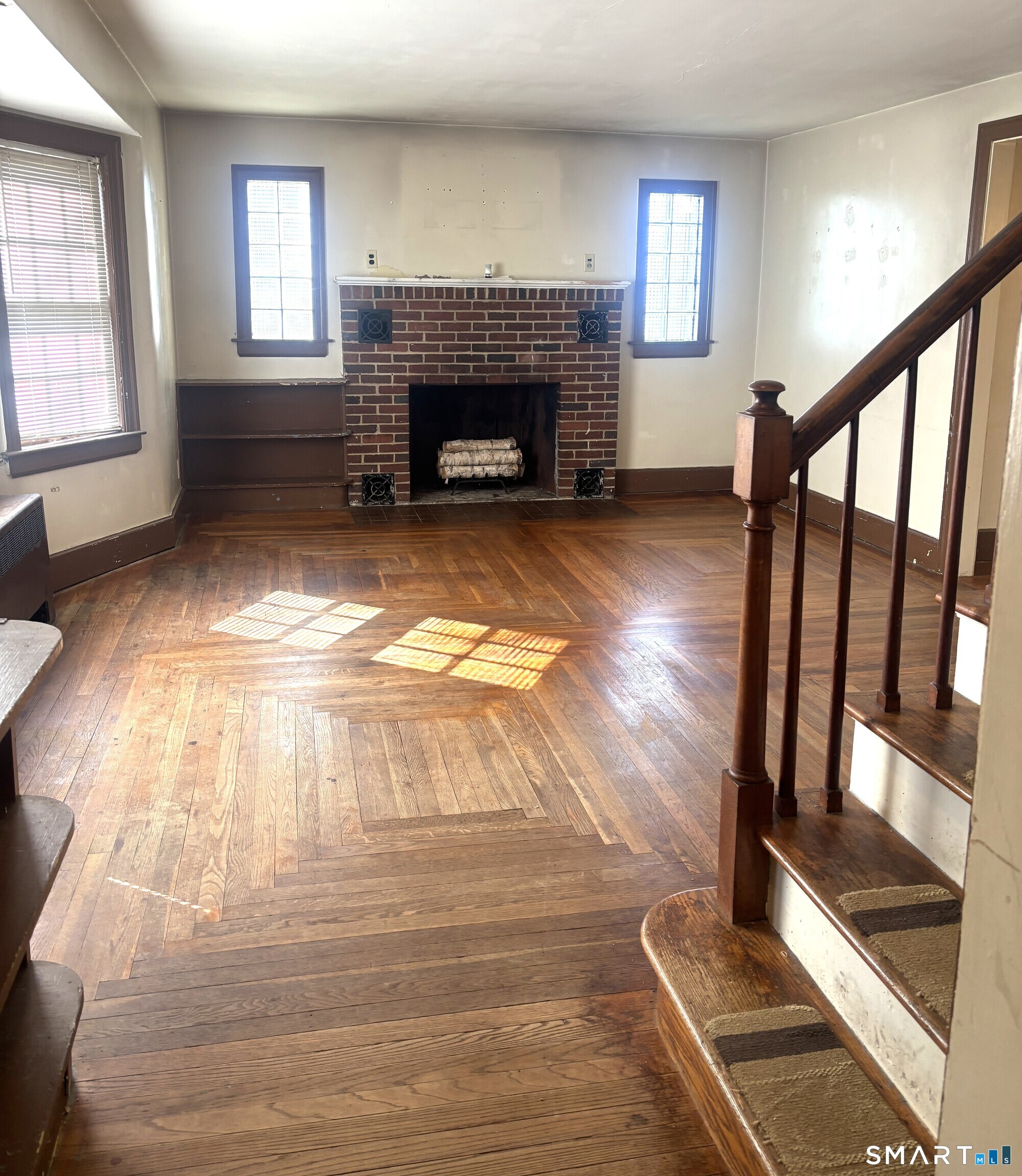 136 Broadway Street Colchester, CT 06415 - Photo 9 of 35 a view of an empty room with wooden floor fireplace and a window