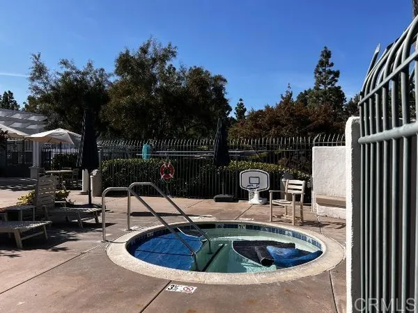 a view of a patio with table and chairs potted plants and palm trees
