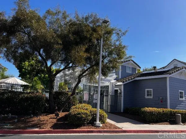 a view of a patio with a table and chairs and potted plants