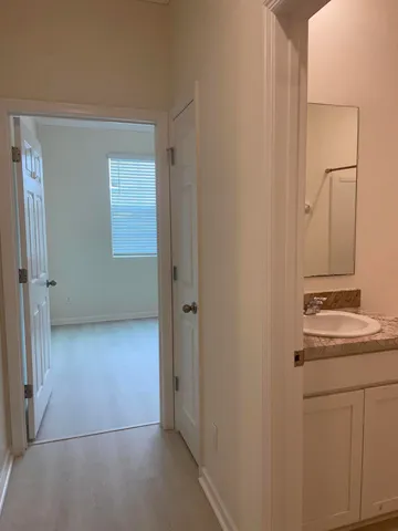 an empty room with windows and closet