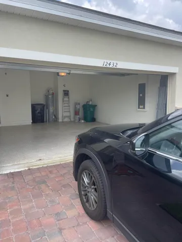 a large white kitchen with stainless steel appliances kitchen island granite countertop a stove a sink a refrigerator and white cabinets