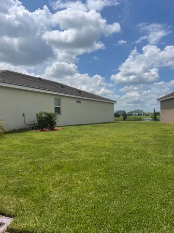 a view of a house with a backyard