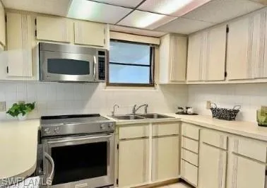 a kitchen with stainless steel appliances a stove microwave and cabinets