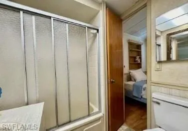 a en suite bathroom with a shower and a sink