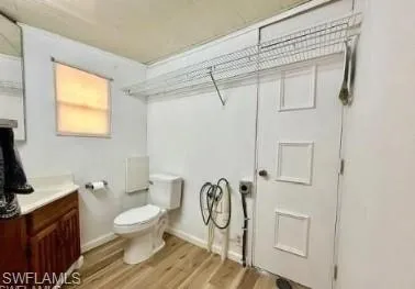 a bathroom with a toilet a sink and a window