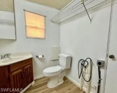a bathroom with a toilet sink vanity and mirror