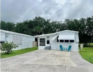 a view of a house with yard and a garden