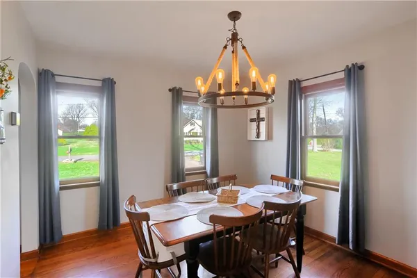 a view of a dining room with a table and chairs