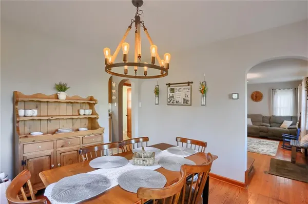 a view of a dining room with furniture a chandelier and wooden floor