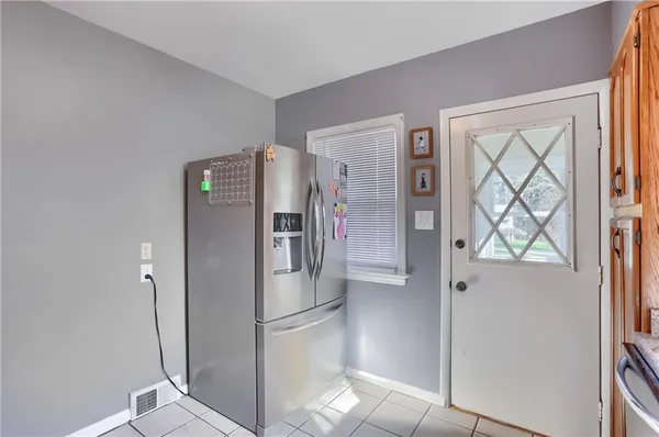 a kitchen with stainless steel appliances a refrigerator and a window