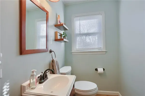 a bathroom with a sink toilet and mirror