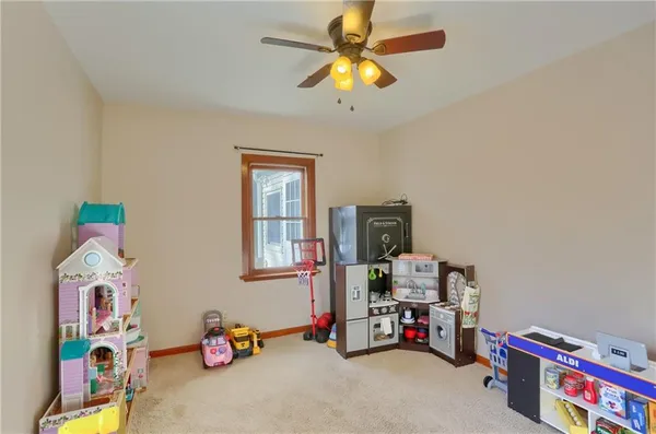 a children room with toys and a fan