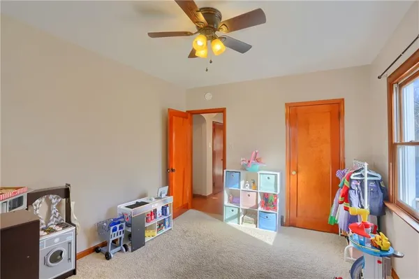 a bedroom with furniture and a book shelf