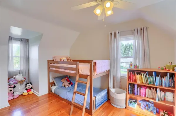a bedroom with furniture and a chandelier fan