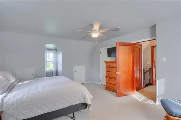 a bedroom with a bed and a dresser