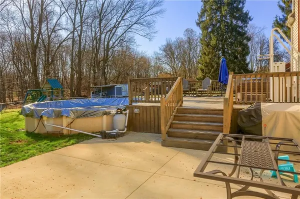 a view of backyard with wooden fence and a large tree
