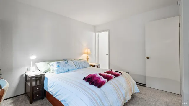 a bedroom with a bed and a lamp