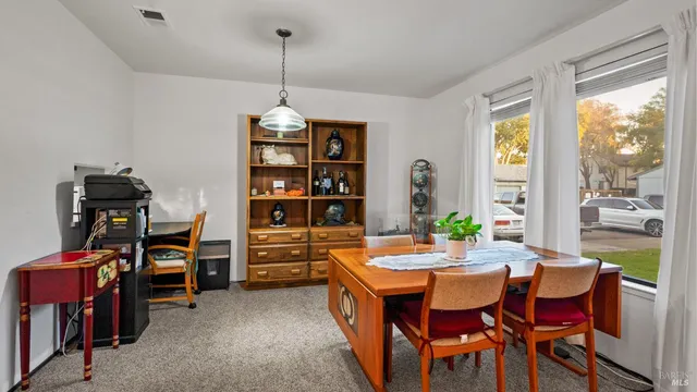 a view of a dining room with furniture window and outside view