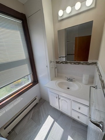 5 Oakland Street Boston, MA 02119 - Photo 14 of 21 a bathroom with a double vanity sink and mirror