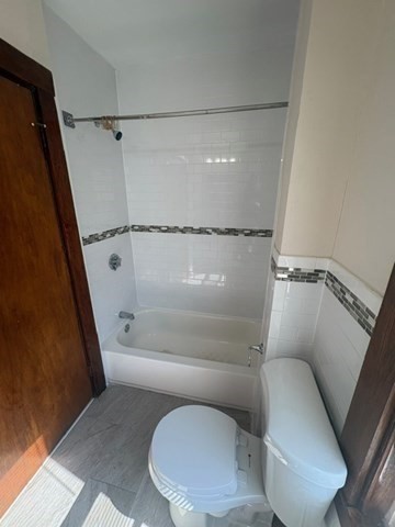 5 Oakland Street Boston, MA 02119 - Photo 15 of 21 a bathroom with a toilet and a shower