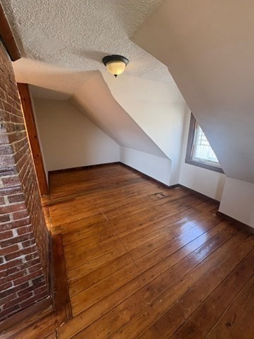 5 Oakland Street Boston, MA 02119 - Photo 18 of 21 a view of an empty room with wooden floor