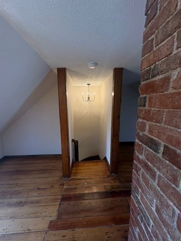5 Oakland Street Boston, MA 02119 - Photo 20 of 21 a view of an empty room with wooden floor and a window