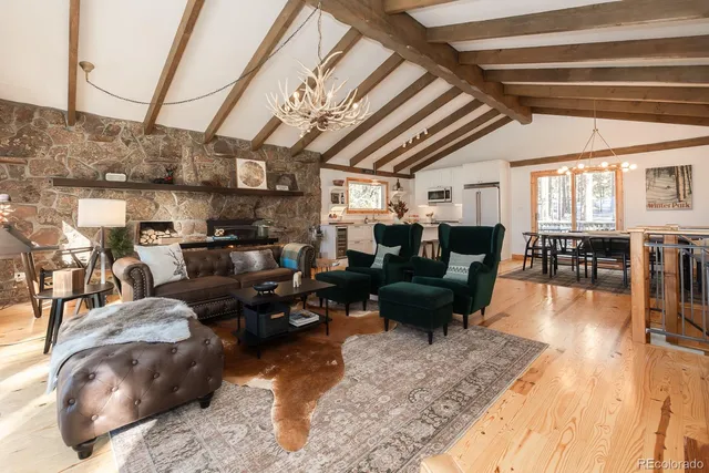 a living room with lots of furniture and a chandelier