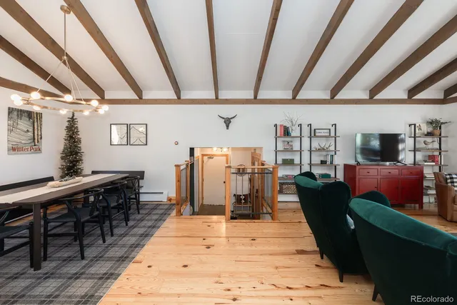 a living room with lots of furniture and wooden floors