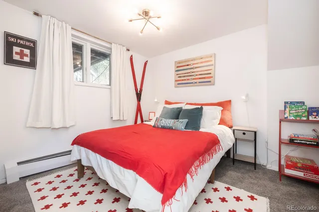 a bathroom with a sink a toilet and shower curtain
