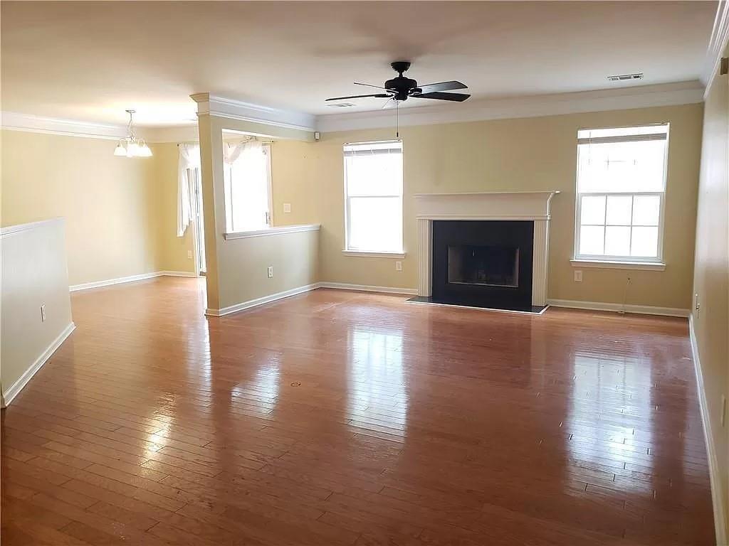 3050 A Centerglen Lane Cumming, GA 30040 - Photo 3 of 10 a view of a livingroom with wooden floor and a fireplace