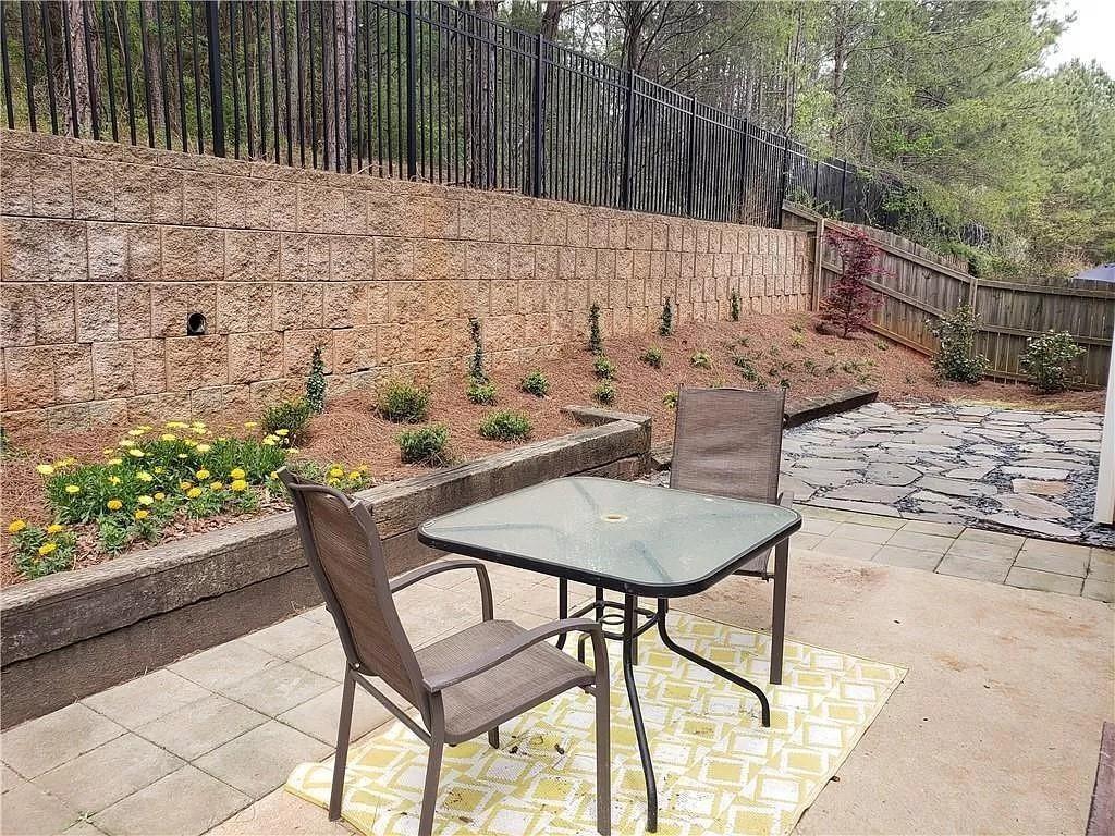 3050 A Centerglen Lane Cumming, GA 30040 - Photo 7 of 10 a backyard of a house with table and chairs