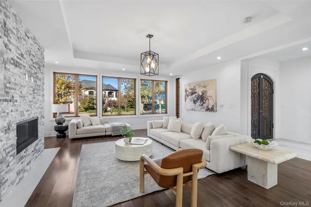 a living room with fireplace furniture and a large window