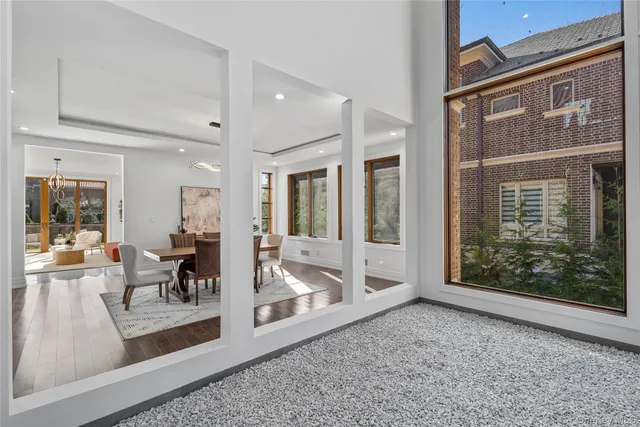 a view of a livingroom with furniture and floor to ceiling window