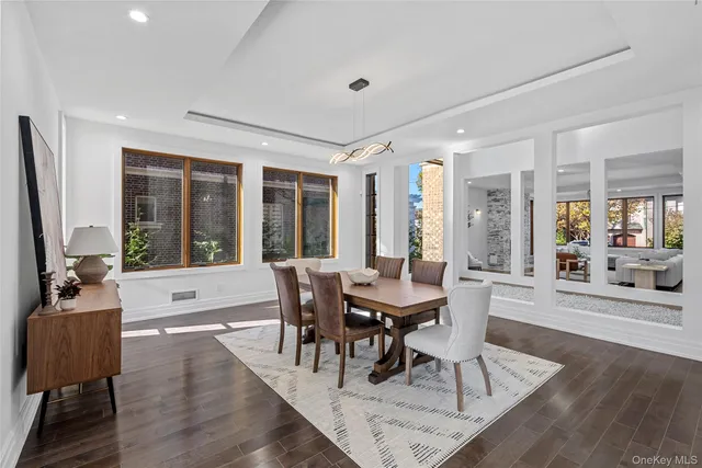 a view of a dining room with furniture wooden floor and a chandelier