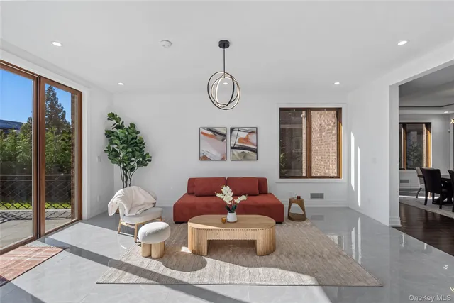 a living room with furniture potted plant and a table